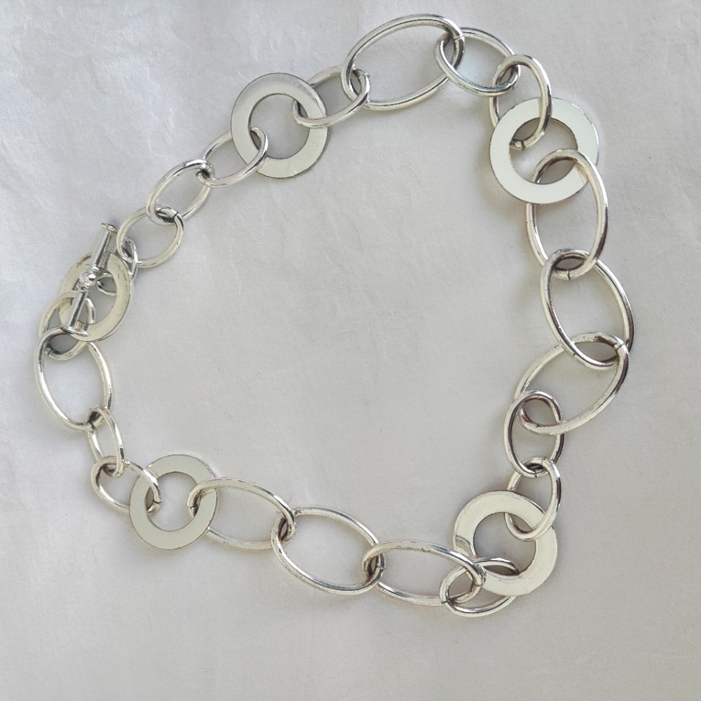 Necklace silver in color.